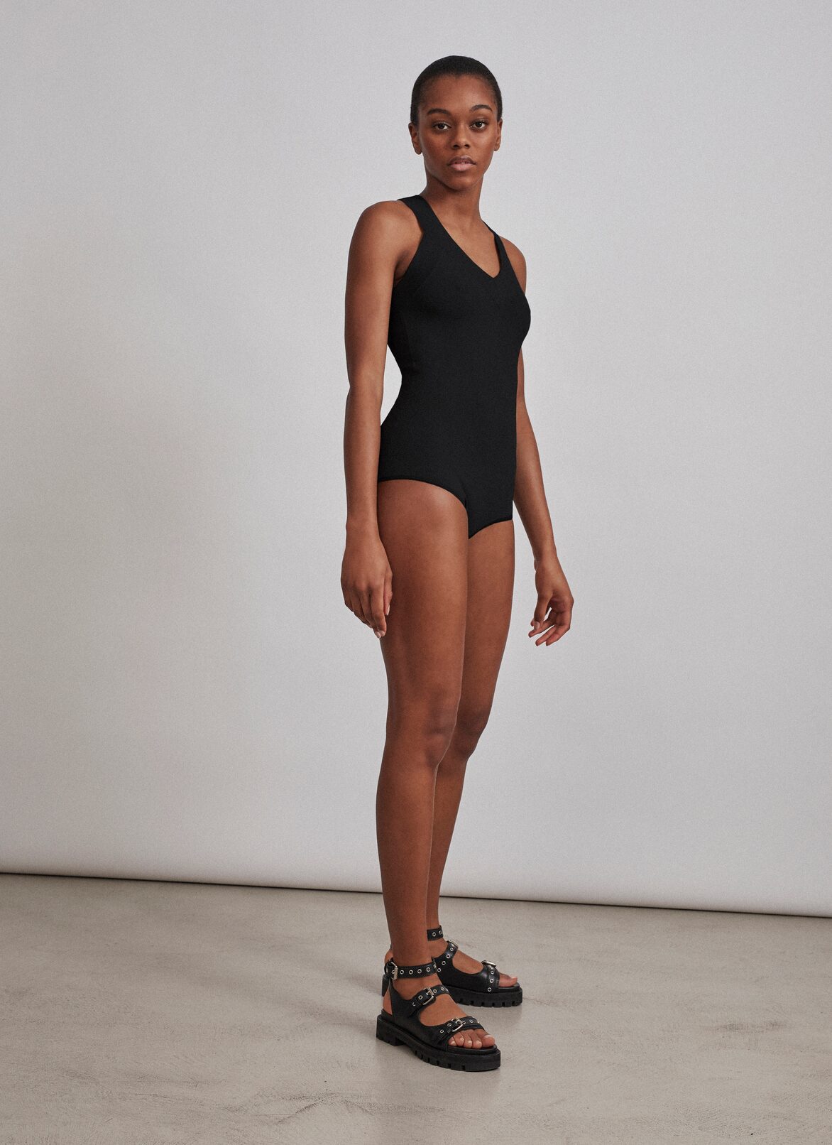 Stretch knit bodysuit with criss-crossed back ALAÏA BLACK STRETCH KNIT BODYSUIT WITH CRISS-CROSSED BACK